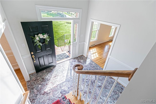 foyer featuring stairs, visible vents, and wood finished floors