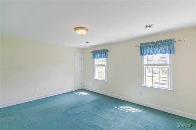 carpeted empty room with baseboards and visible vents