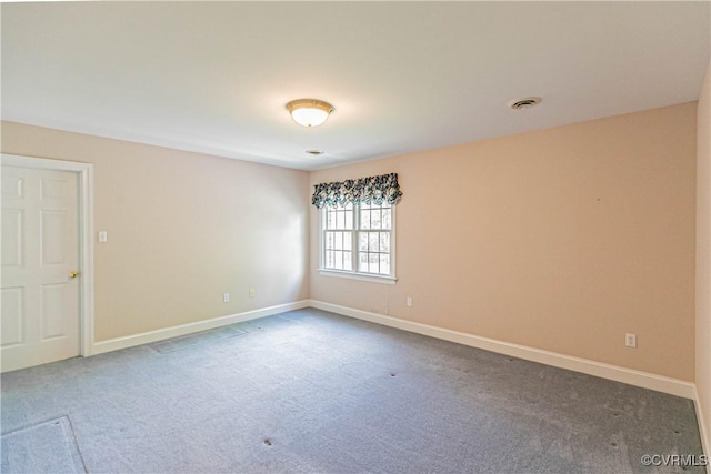 carpeted spare room featuring baseboards and visible vents