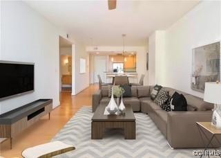 living area with wood finished floors and ceiling fan
