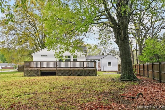 view of yard with a deck and fence