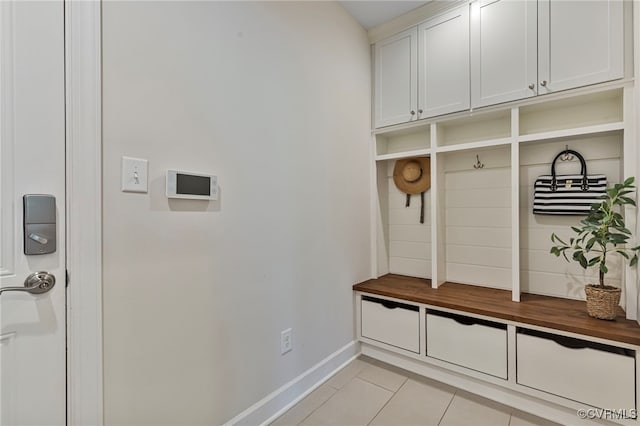 mudroom with baseboards and light tile patterned flooring