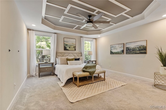 bedroom with baseboards, multiple windows, light carpet, and ceiling fan