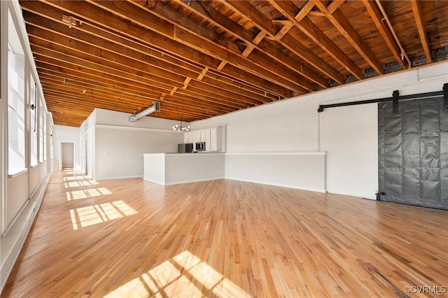 1716 Summit Ave Unit 30, Richmond, VA 23230 - interior space featuring baseboards, a barn door, and light wood finished floors