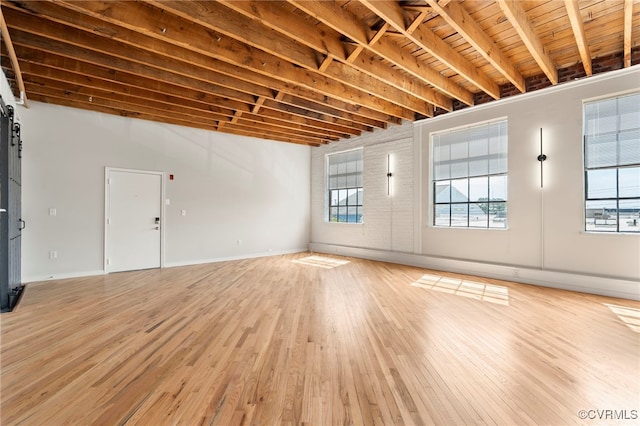1716 Summit Ave Unit 30, Richmond, VA 23230 - unfurnished living room with baseboards, wooden ceiling, beam ceiling, and light wood-style floors