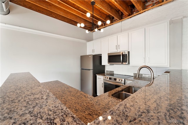 1716 Summit Ave Unit 30, Richmond, VA 23230 - kitchen with white cabinets, appliances with stainless steel finishes, a sink, and dark stone countertops