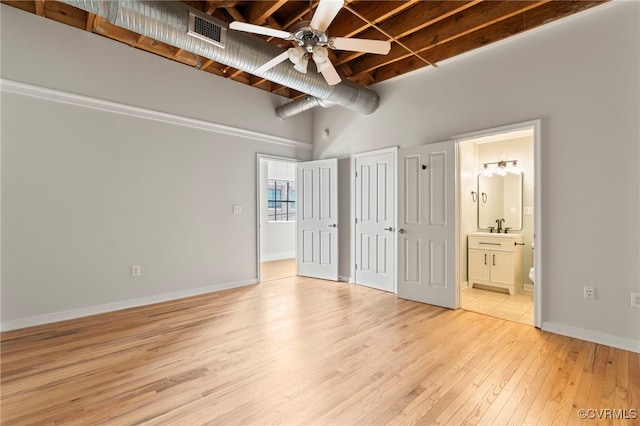 1716 Summit Ave Unit 30, Richmond, VA 23230 - unfurnished bedroom featuring visible vents, wood finished floors, a sink, connected bathroom, and a high ceiling