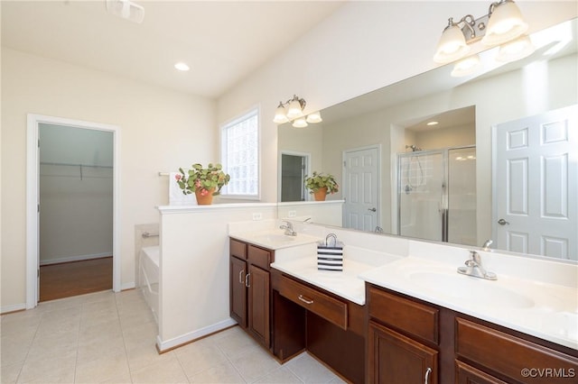 7516 Shadow Lands Ct, Mechanicsville, VA 23111 - bathroom featuring a shower stall, double vanity, a bath, tile patterned flooring, and a spacious closet