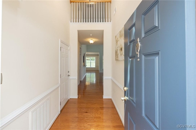 7516 Shadow Lands Ct, Mechanicsville, VA 23111 - hall featuring light wood-style flooring, a towering ceiling, and baseboards