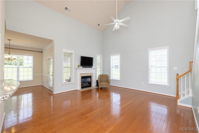 7516 Shadow Lands Ct, Mechanicsville, VA 23111 - unfurnished living room with wood finished floors, baseboards, a chandelier, a fireplace with flush hearth, and high vaulted ceiling