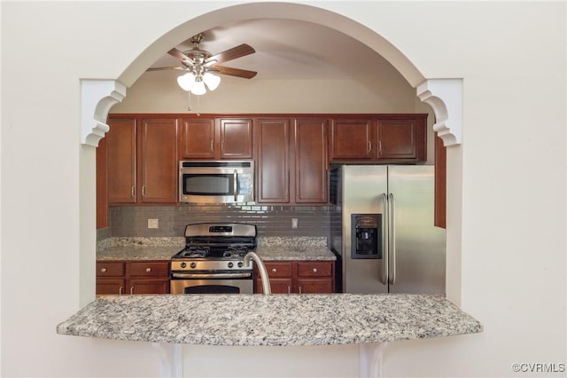7516 Shadow Lands Ct, Mechanicsville, VA 23111 - kitchen featuring appliances with stainless steel finishes, a ceiling fan, decorative backsplash, and light stone counters