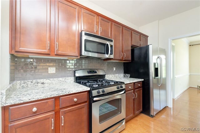 7516 Shadow Lands Ct, Mechanicsville, VA 23111 - kitchen featuring stainless steel appliances, light wood-type flooring, backsplash, light stone counters, and brown cabinets