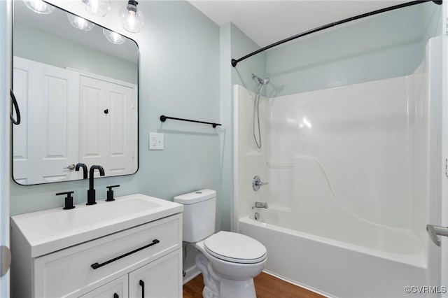 bathroom featuring shower / bath combination, vanity, toilet, and wood finished floors