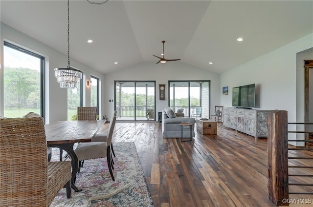 dining room featuring lofted ceiling, dark wood-type flooring, and ceiling fan with notable chandelier