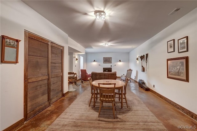 dining area with visible vents, finished concrete flooring, and baseboards