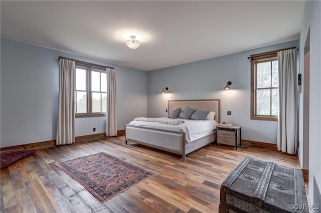 bedroom featuring wood finished floors and baseboards