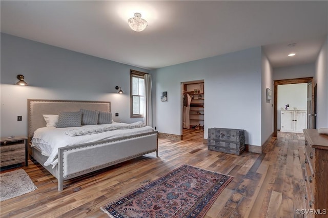 bedroom featuring baseboards and wood finished floors