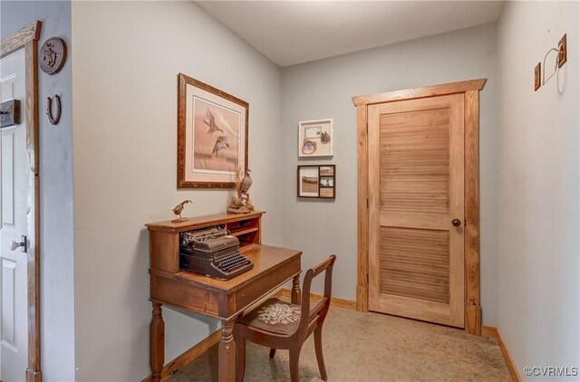 doorway featuring baseboards