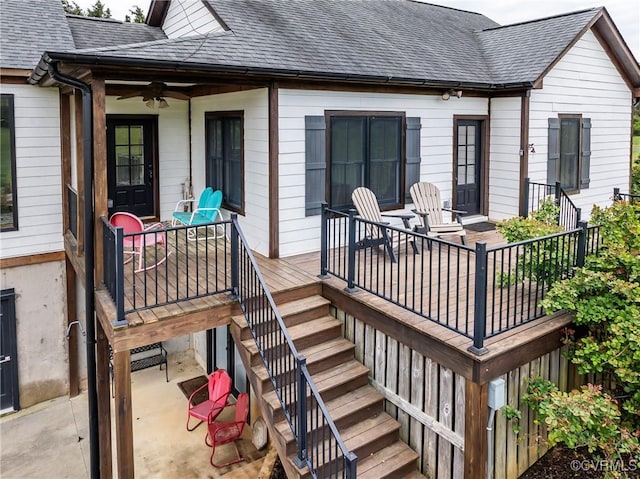 wooden deck featuring stairs and ceiling fan