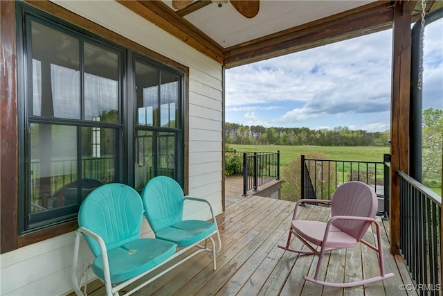 wooden terrace with a ceiling fan