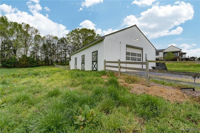 view of pole building featuring fence