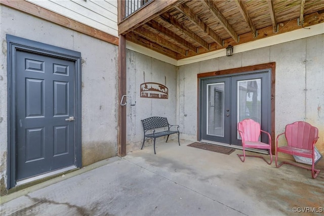 view of exterior entry with a patio area