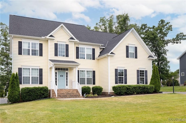 colonial inspired home featuring a front yard
