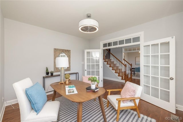 dining room with baseboards, wood finished floors, stairway, and french doors