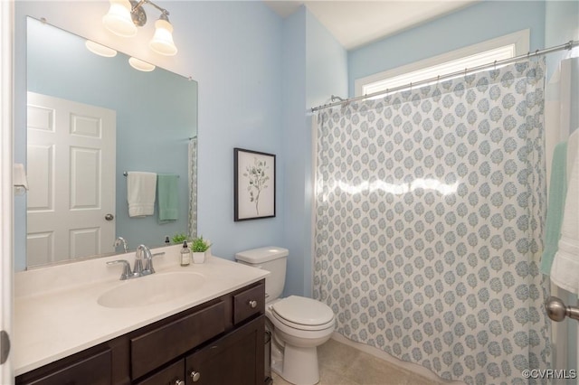 bathroom featuring toilet, curtained shower, and vanity