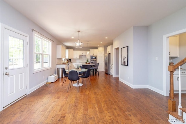 dining space with recessed lighting, baseboards, and dark wood-style floors