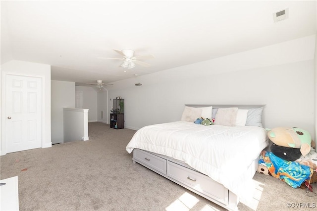bedroom featuring visible vents, baseboards, ceiling fan, and light carpet