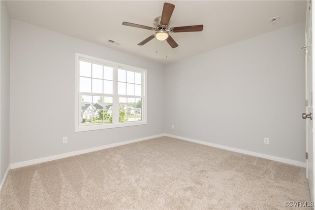 empty room with visible vents, baseboards, and carpet floors