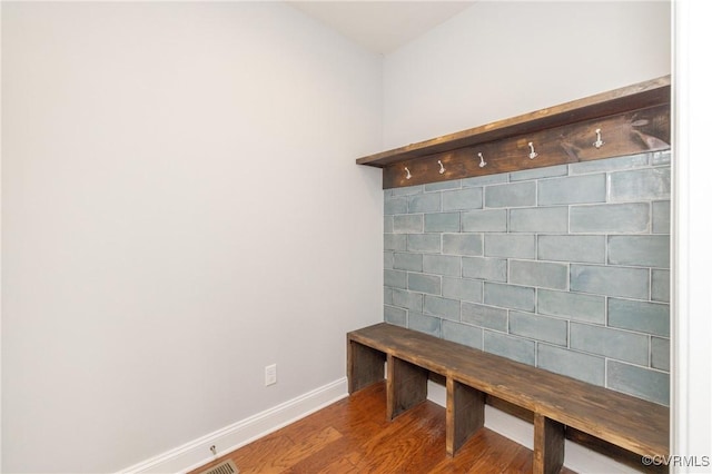 mudroom featuring baseboards and wood finished floors