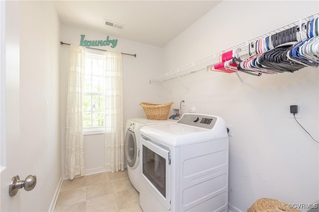 laundry room with visible vents, laundry area, baseboards, and separate washer and dryer