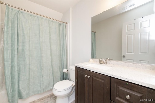bathroom with visible vents, a shower with curtain, toilet, and vanity