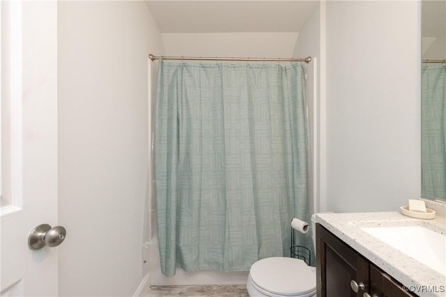 bathroom with vanity, toilet, and shower / tub combo with curtain