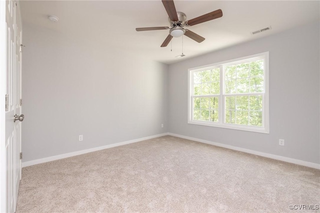 spare room with visible vents, carpet, ceiling fan, and baseboards