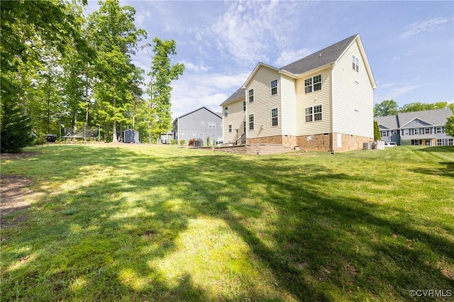 back of property with a storage shed, a yard, and cooling unit