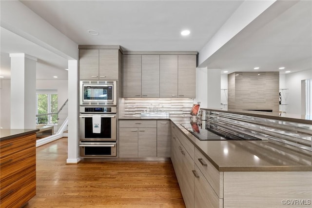 3 Welwyn Pl, Henrico, VA 23229 - kitchen with stainless steel microwave, modern cabinets, light wood-style flooring, black electric stovetop, and gray cabinetry