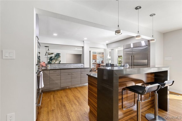 3 Welwyn Pl, Henrico, VA 23229 - kitchen featuring stainless steel built in fridge, modern cabinets, dark countertops, a breakfast bar, and light wood-type flooring