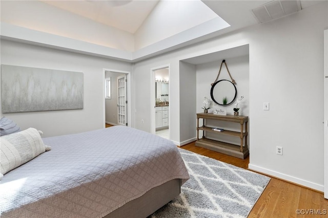 3 Welwyn Pl, Henrico, VA 23229 - bedroom with wood finished floors, baseboards, ensuite bath, and vaulted ceiling