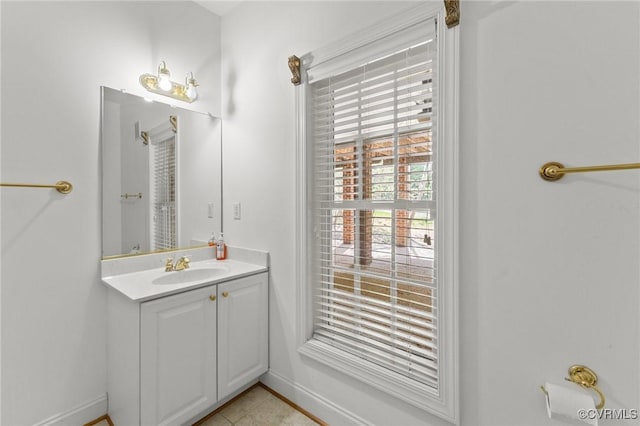 bathroom with tile patterned floors, vanity, and baseboards