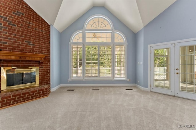 unfurnished living room featuring visible vents, a wealth of natural light, and carpet