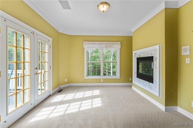 unfurnished living room featuring crown molding, carpet flooring, and baseboards