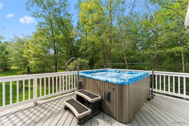 wooden deck with a hot tub
