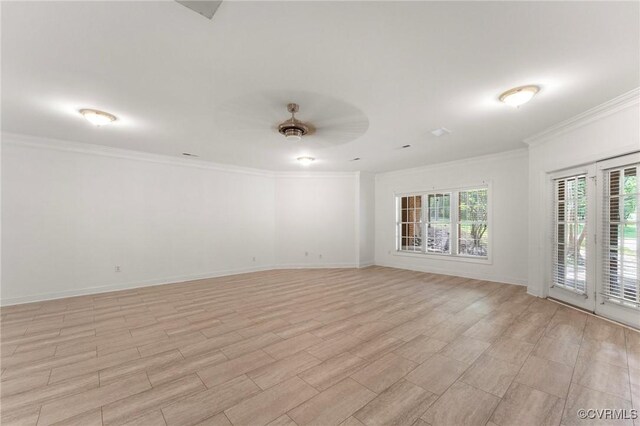 empty room with crown molding, a ceiling fan, and baseboards