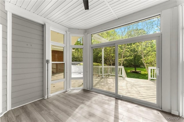 unfurnished sunroom featuring ceiling fan
