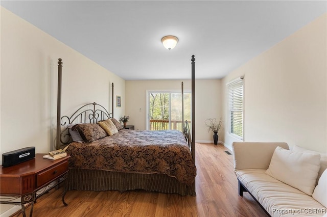 637 Mallard Bay Dr, Heathsville, VA 22473 - bedroom with baseboards, access to outside, and wood finished floors