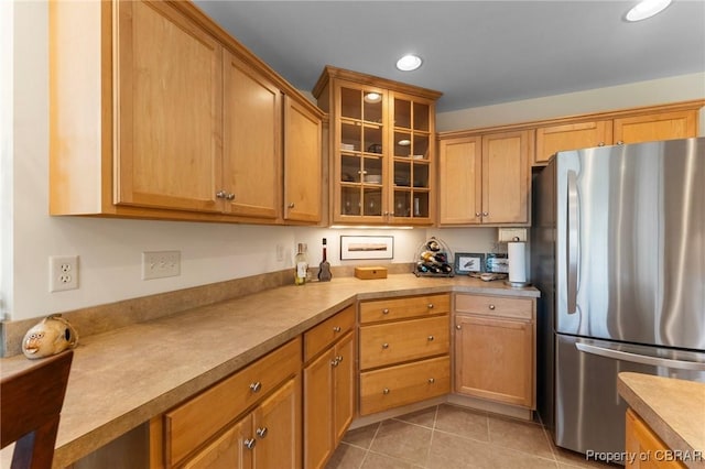637 Mallard Bay Dr, Heathsville, VA 22473 - kitchen featuring freestanding refrigerator, light tile patterned floors, glass insert cabinets, recessed lighting, and light countertops