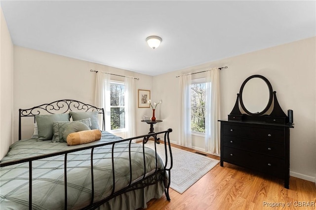 637 Mallard Bay Dr, Heathsville, VA 22473 - bedroom featuring baseboards, light wood-style floors, multiple windows, and visible vents